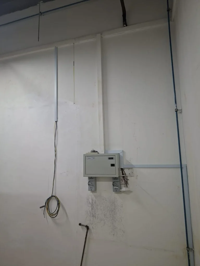 Completed surface distribution board by Best Volt in the Audanis Bakes unit, two isolators below and conduit dropping from the ceiling.