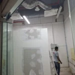 Interior first fix by Best Volt at Audanis Bakes, with silver duct, fluorescent fittings, and a gypsum partition.