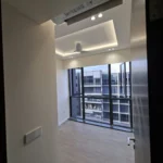 A separate bedroom in the same condominium, cove lighting and ceiling fan against a full-height black window, two-gang switch at the door, by Best Volt.